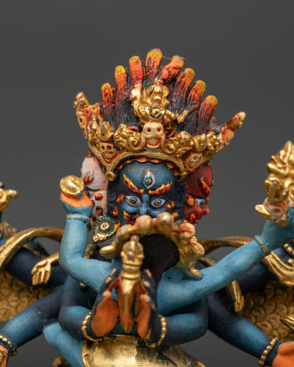 Close-up of wrathful Vajrakilaya three-headed face with hand-painted details and gold accents