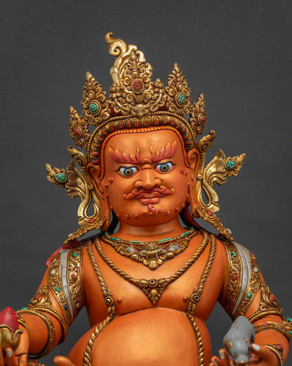 Close up of Yellow Dzambhala statue showing gold gilded jewelry and semi precious stone details