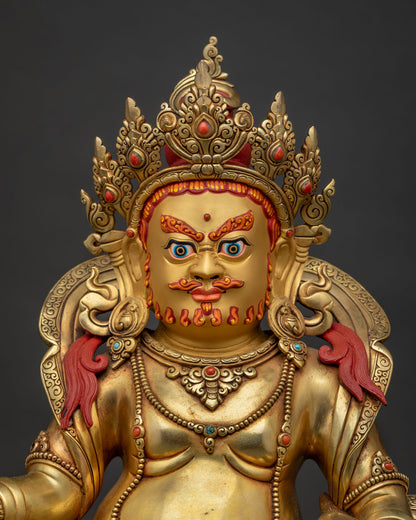 close up of Yellow Dzambhala statue showing gold gilding, jeweled crown, and intricate ornaments