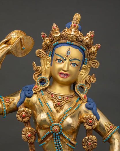 Close up of Yumka Dechen Gyalmo Dakini statue showing gold painted face and intricate ornaments