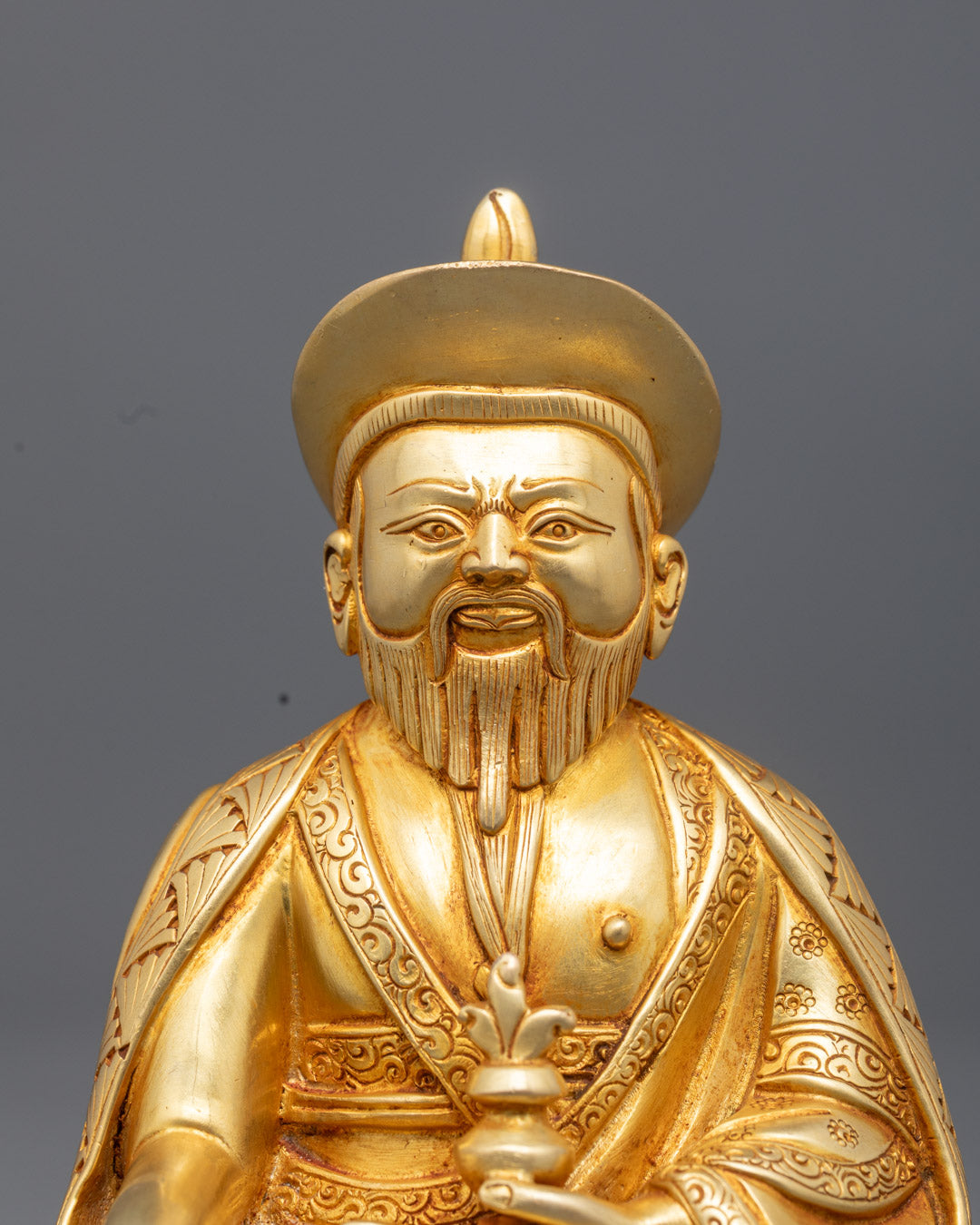 Close up of Zhabdrung Namgyal statue showing fire gilded gold and intricate details