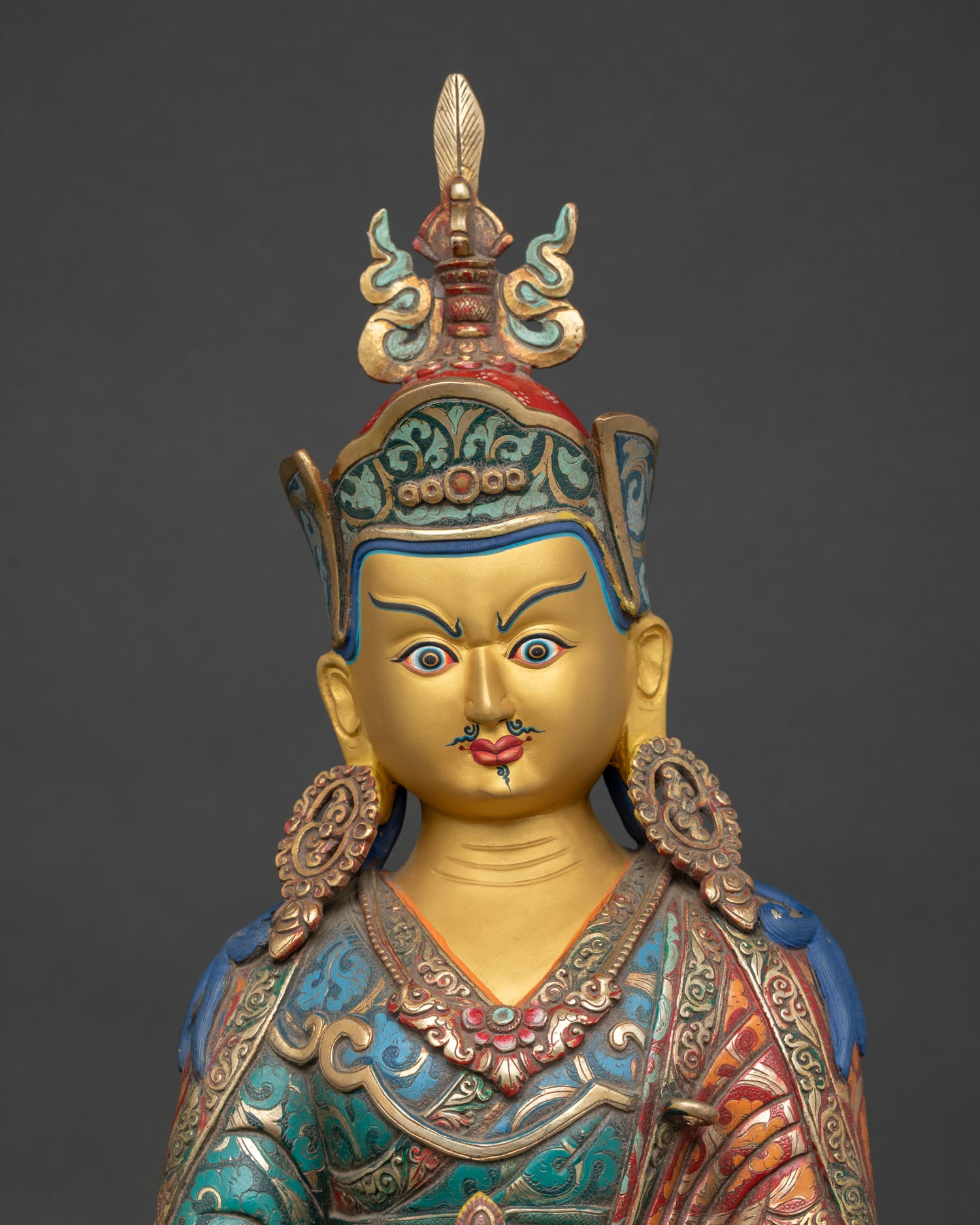 Close-up Padmasambhava Statue holding vajra kapala and khatvanga trident, tantric Buddhist deity, sacred detail