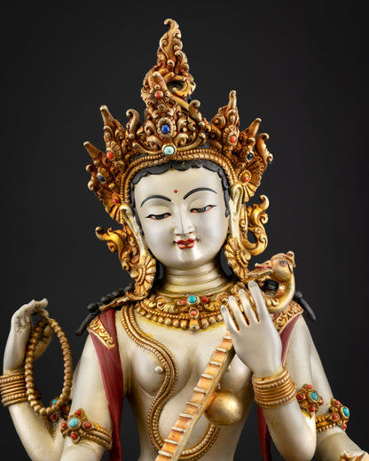Close up Saraswati Devi statue detail face semi precious stones floral motifs Newari artisan craftsmanship Himalayan goddess of knowledge music and arts sculpture