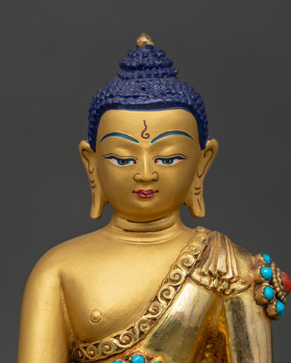 Close up Shakyamuni Buddha face detail gold gilded expression earth touching mudra turquoise coral inlay Newari handcrafted Buddhist sculpture