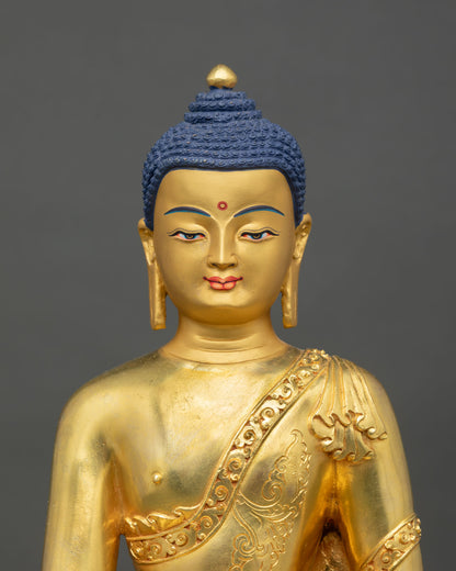 Close up Shakyamuni Buddha face detail gold painted serene expression Himalayan Newari craftsmanship Patan Buddhist sacred art