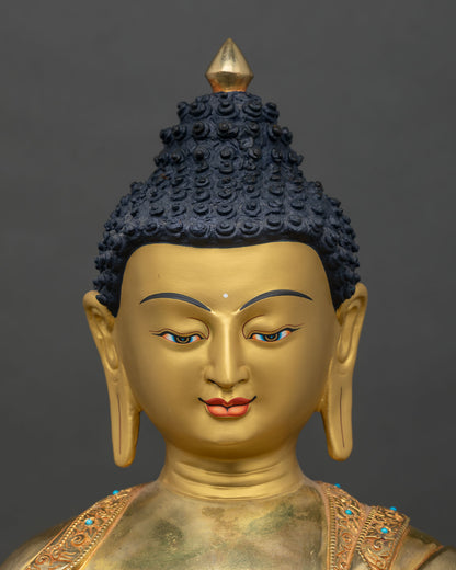 Close up Shakyamuni Buddha face gold-painted copper Himalayan artisan sculpture