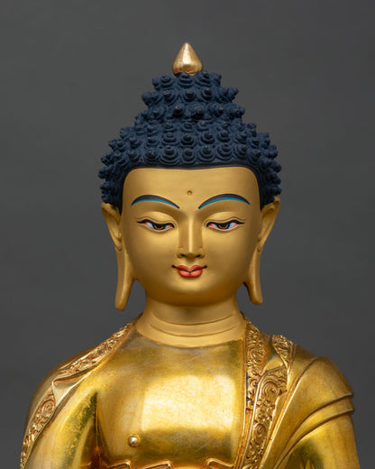 Close up Shakyamuni Buddha face gold-painted copper Himalayan artisan statue
