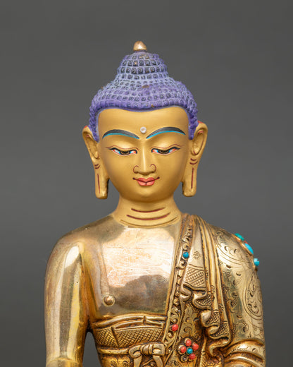 Close up of Shakyamuni Buddha face serene expression gold painted copper Himalayan sculpture