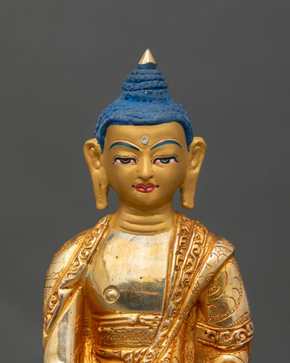 Close up Shakyamuni Buddha gold painted face copper statue Newari art lost wax casting detail