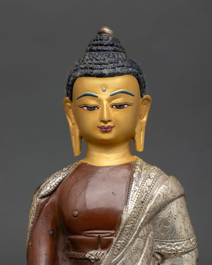 Close up Shakyamuni Buddha gold painted serene face detail copper statue with oxidized silver plated finish