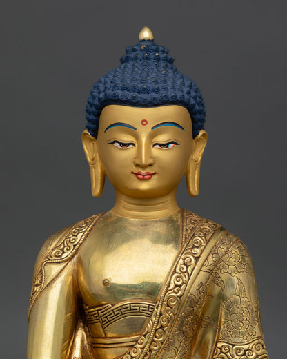 Close up Shakyamuni Buddha serene gold finished face Nepalese artisan craftsmanship lost wax casting spiritual sculpture radiant calm expression