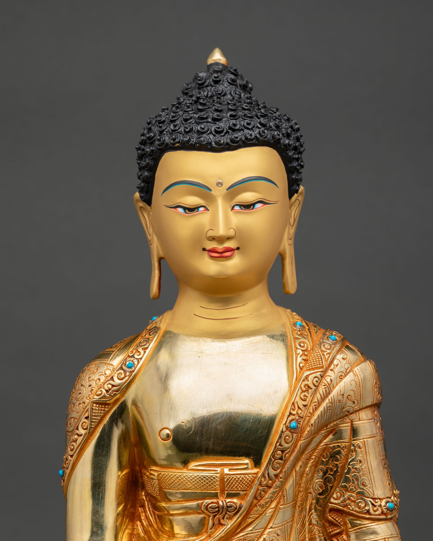 Close up Shakyamuni Buddha serene gold painted face detail, Nepalese craftsmanship