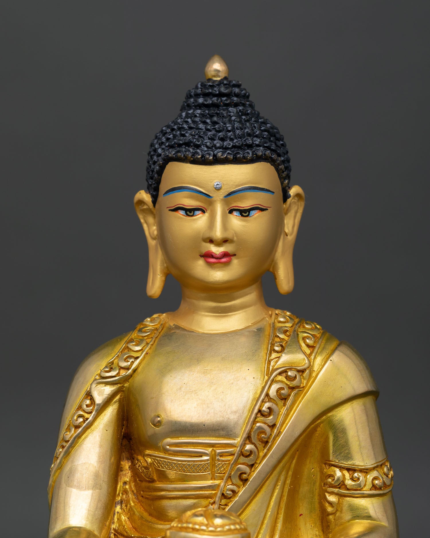 Close up Shakyamuni Buddha serene gold painted face with floral decorated halo