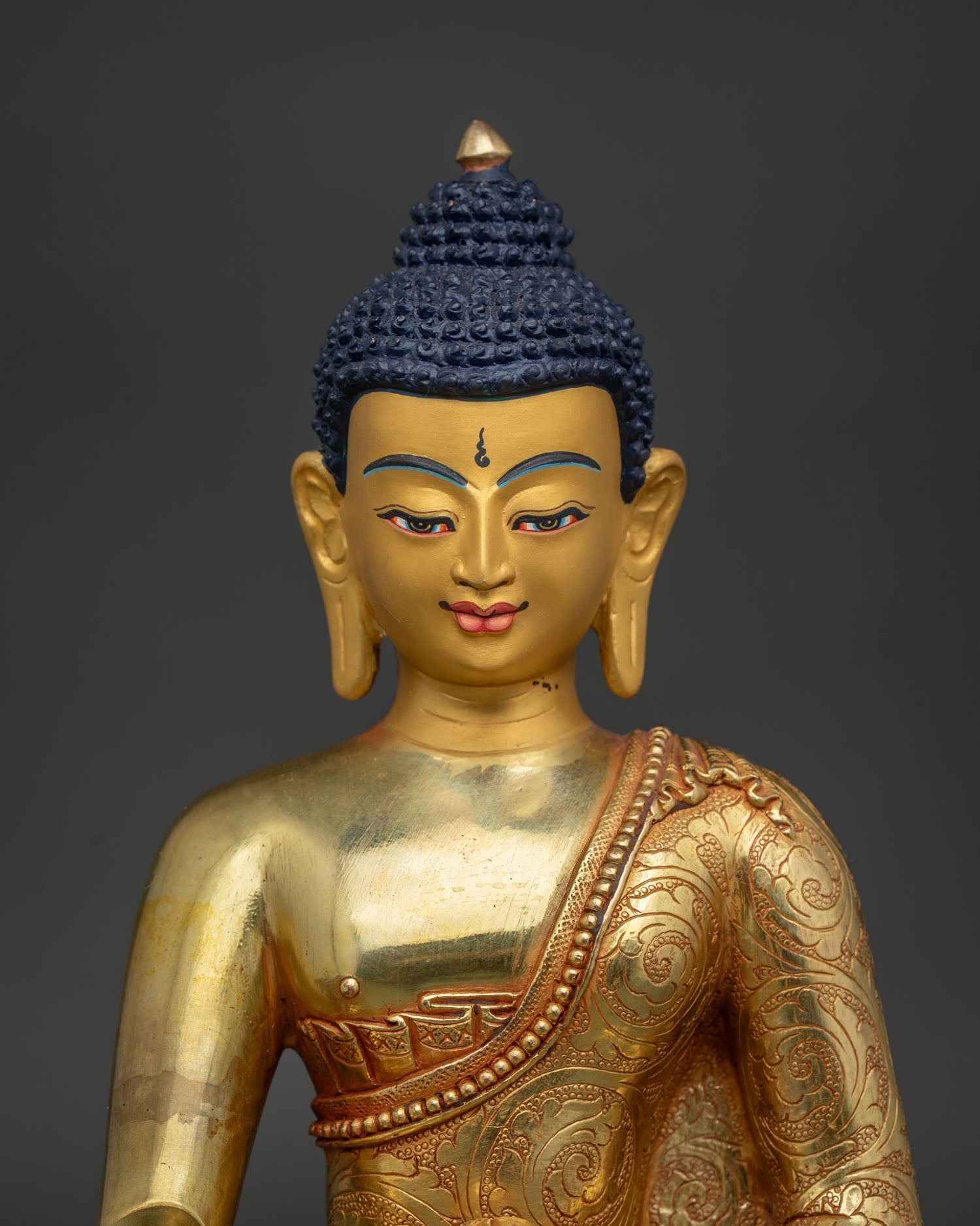 Close Up Shakyamuni Buddha Statue Gold Painted Face and Floral Robe Carving.