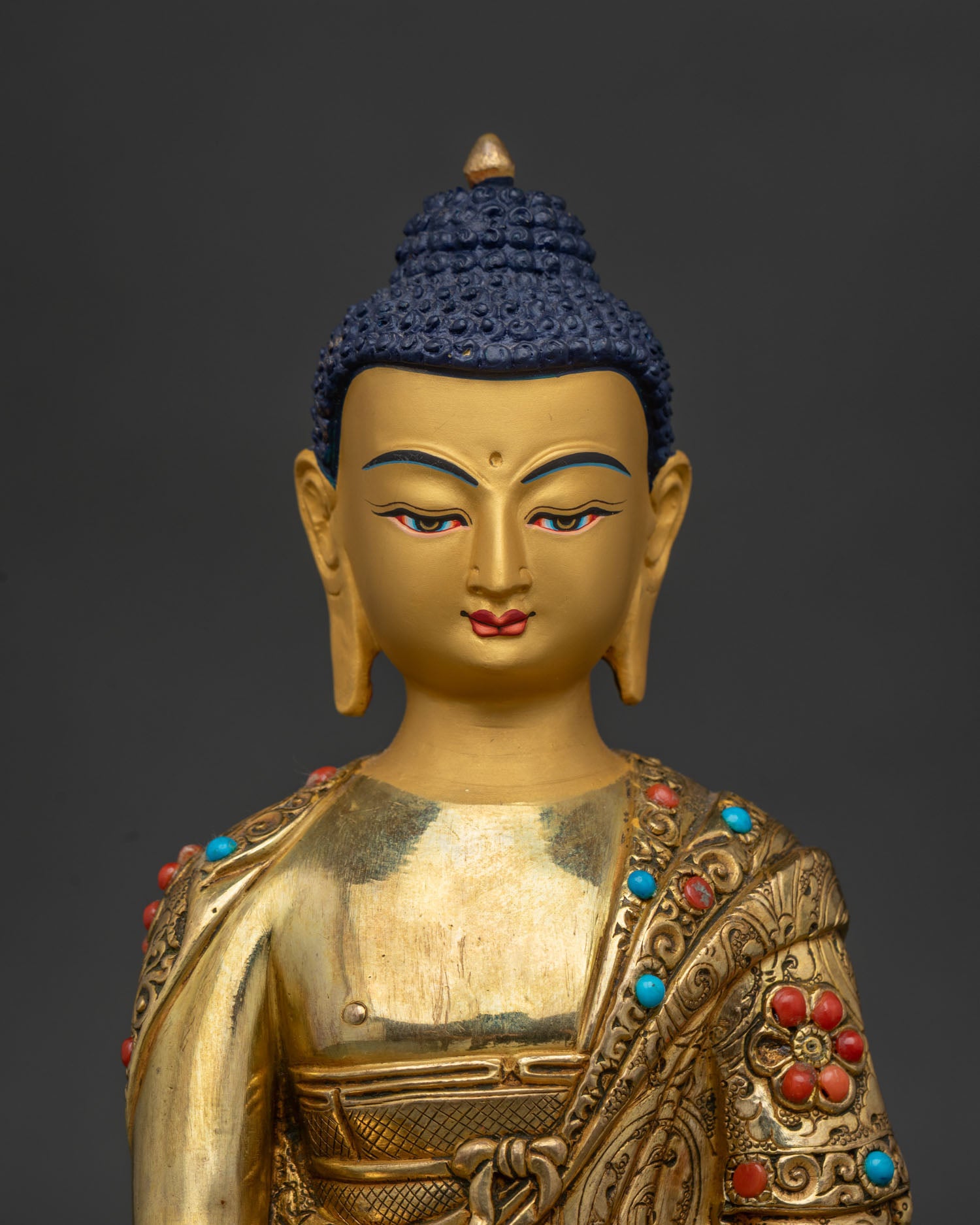 Close Up Shakyamuni Buddha Statue Gold Painted Face with Semi Precious Stone Details.