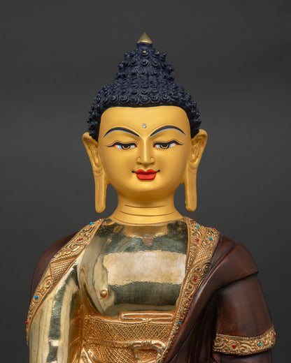 Close Up Shakyamuni Buddha Statue Showing Deep Blue Eyes Gentle Smile and Gold Gilding.