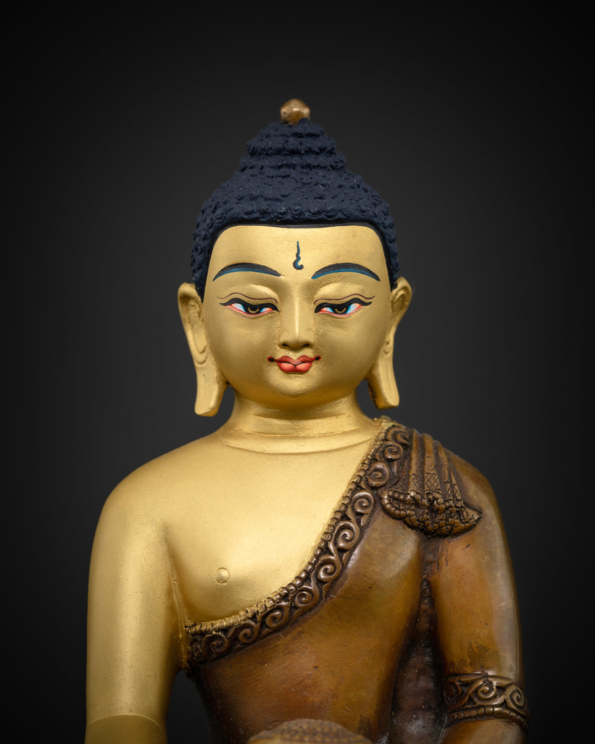 Close up shakyamuni buddha statue with deep blue hand painted acrylic eyes.