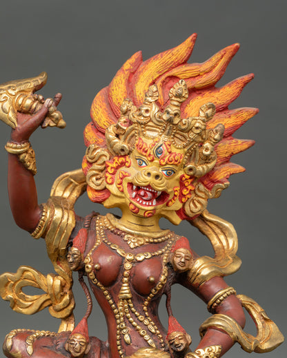 Close up of Simha Mukha face, third eye gold-painted face, crown lotus seat, Himalayan protector