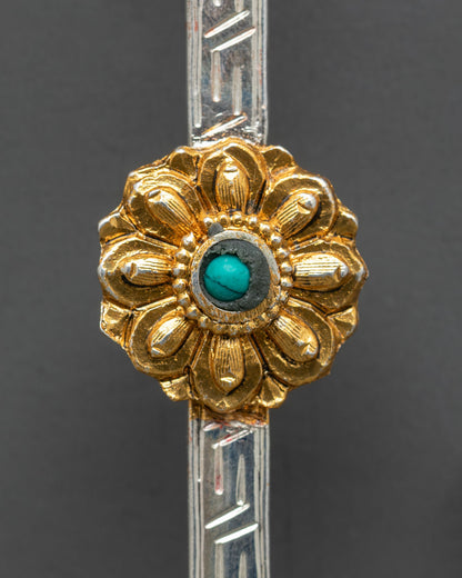 Close up tibetan spoon detailed engraving meander pattern turquoise vajrayana ritual craftsmanship kathmandu valley