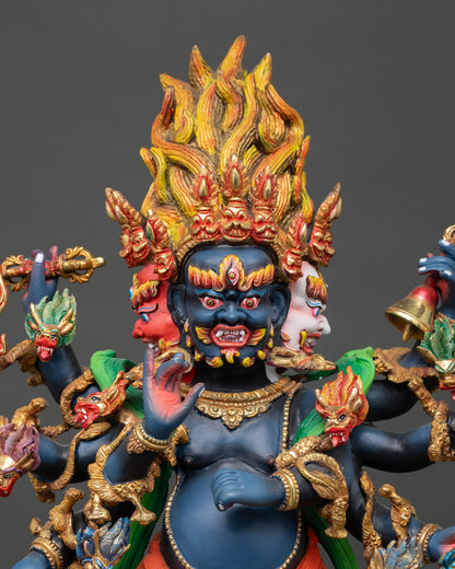 Close up Ucchusma three wrathful faces with multiple arms holding ritual implements symbolizing destruction of ignorance and obstacles