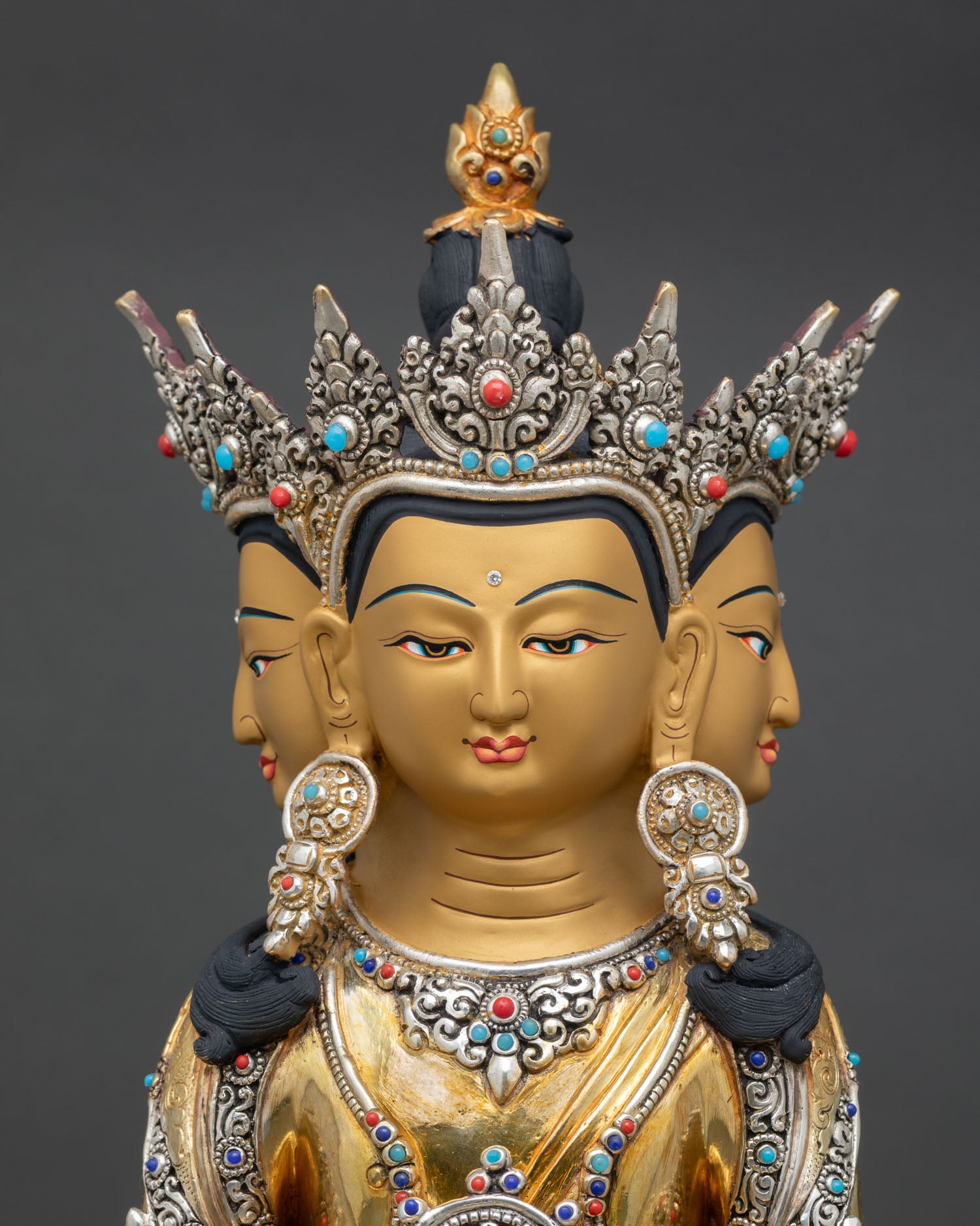Close up Vairocana Buddha face and five jeweled crown gold gilded Nepal Buddhist sculpture semi precious stone detailing