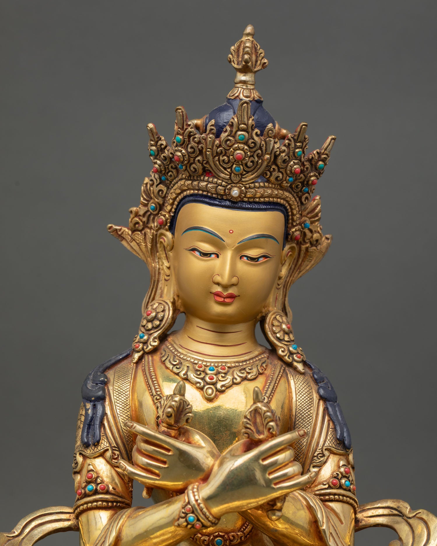 Close up Vajradhara face gold painted serene expression handcrafted Nepal