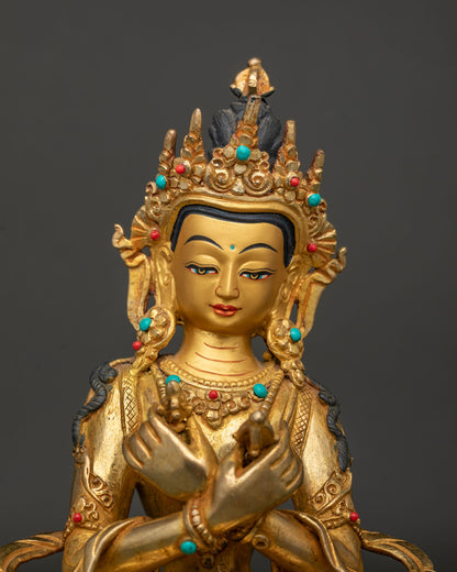 Close up vajradhara statue showing detailed crown ornaments robes and gold gilded craftsmanship.