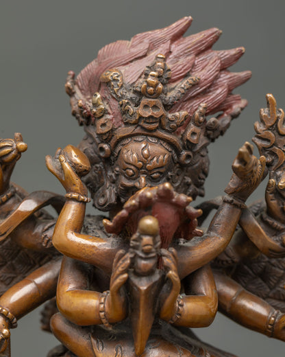 Close up Vajrakilaya face showing intricate carving wings and wrathful expression.