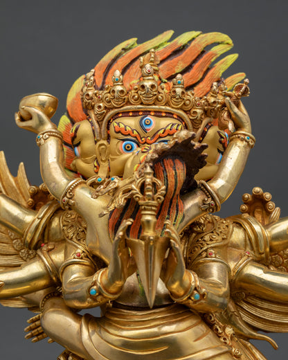 Close up Vajrakilaya wrathful face with turquoise coral stones Himalayan statue