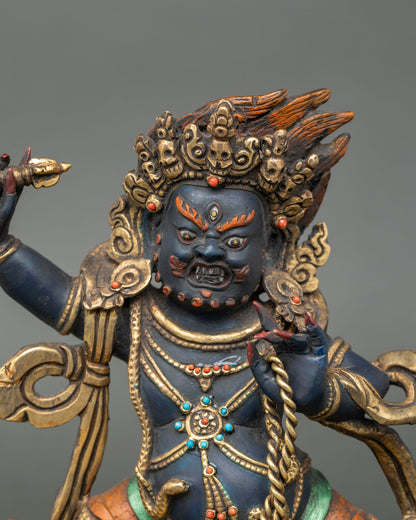 Close up of Vajrapani face acrylic hand-painted gold gilded halo raised vajra Himalayan sculpture
