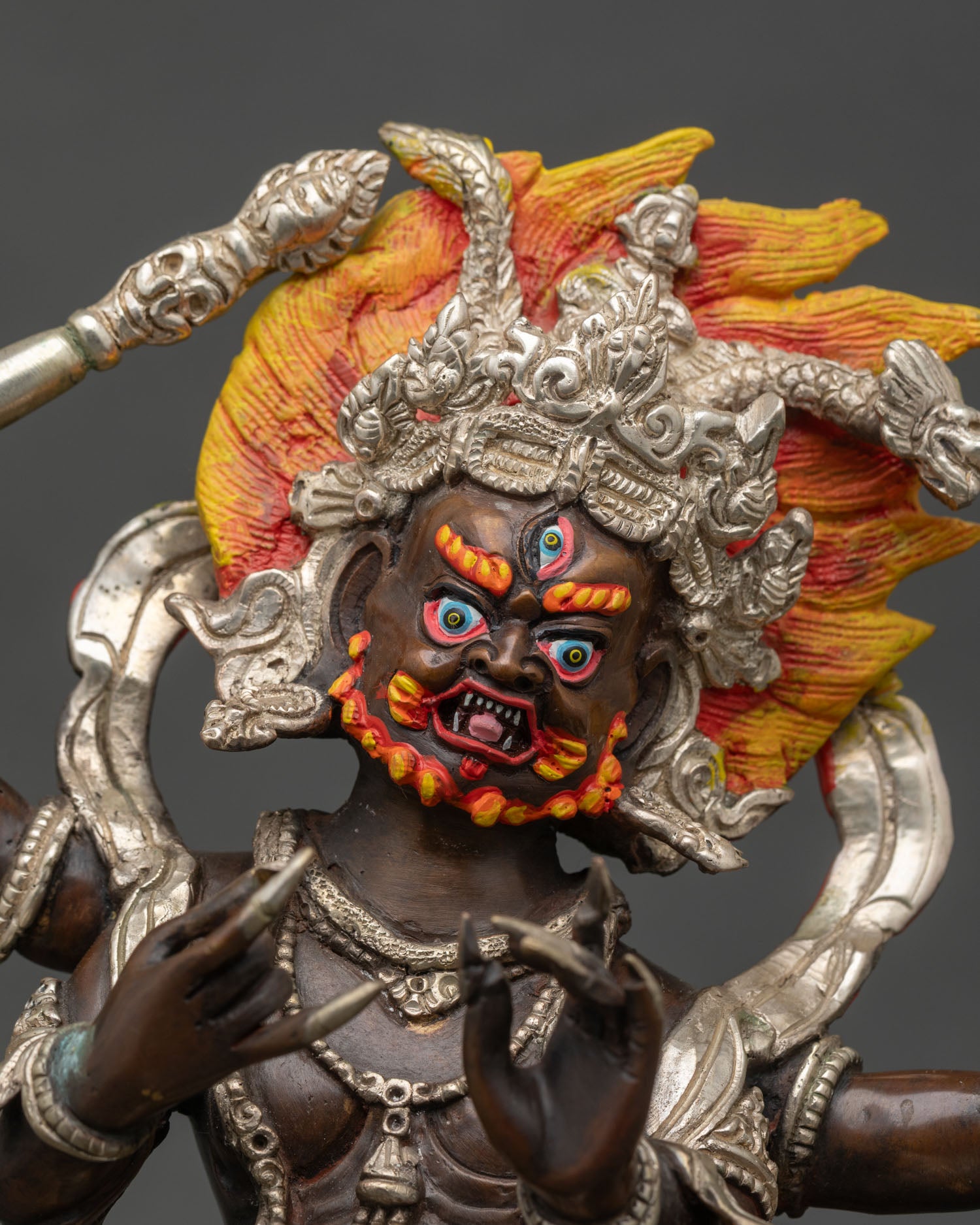 Close up Vajrapani face detail third eye wrathful protector deity Himalayan Buddhist art Newari craftsmanship sacred sculpture divine awareness expression