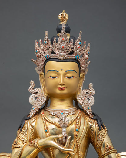 Close up Vajrasattva Buddha statue serene face vajra and bell symbols semi precious stones and intricate Himalayan craftsmanship details