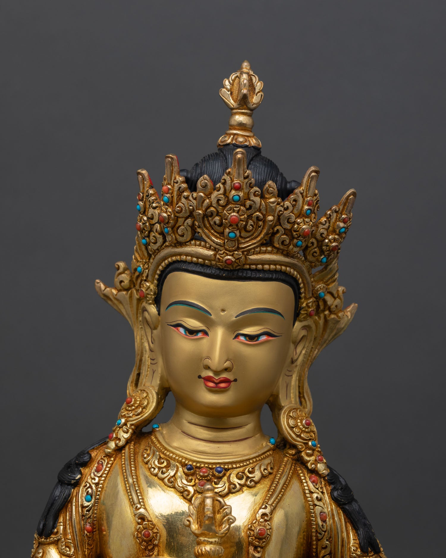 Close up Vajrasattva face gold painted expression with semi precious stones detailed craftsmanship