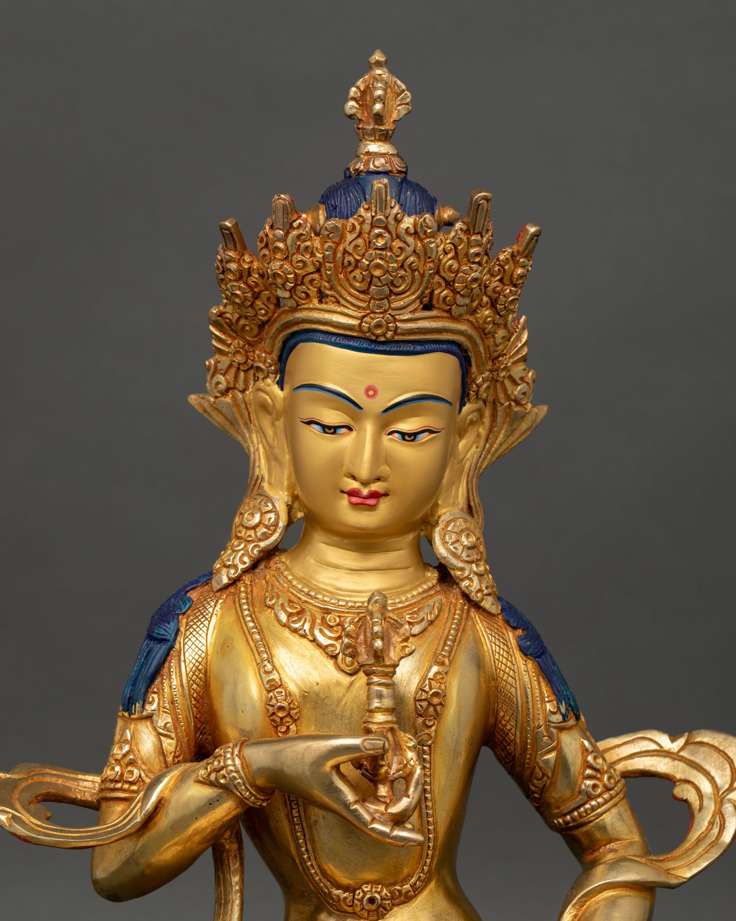 Close up Vajrasattva face gold painted serene expression handmade Nepal