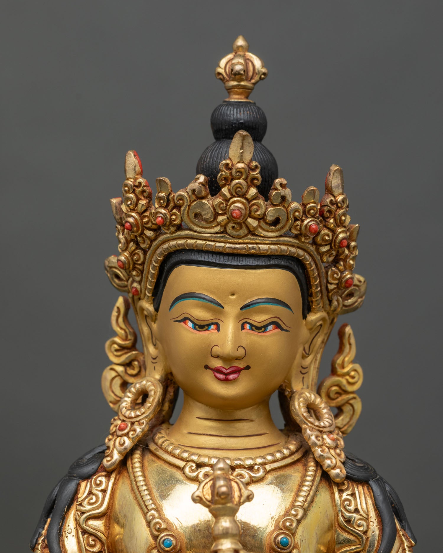 Close-up of Vajrasattva statue showing intricate gold and gemstone details