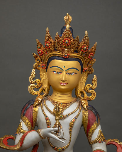 Close-up of Vajrasattva statue showing vajra and bell, hand-cast copper craftsmanship