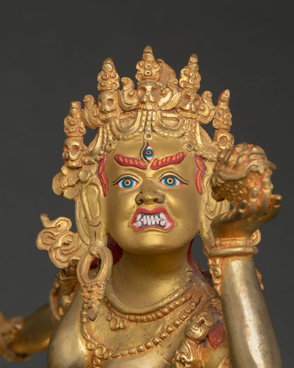 Close up Vajrayogini goddess statue showing gold painted face third eye wrathful expression, skull cup with intricate Nepalese craftsmanship.