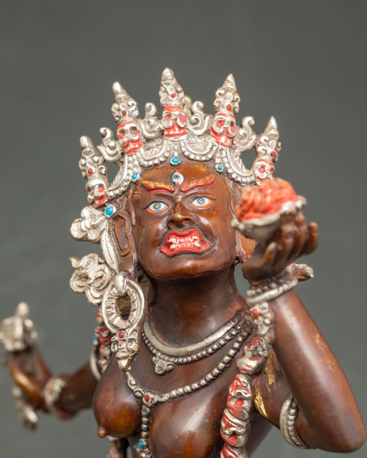 Close-up Vajrayogini statue, dynamic posture, intricate carvings, Tibetan deity