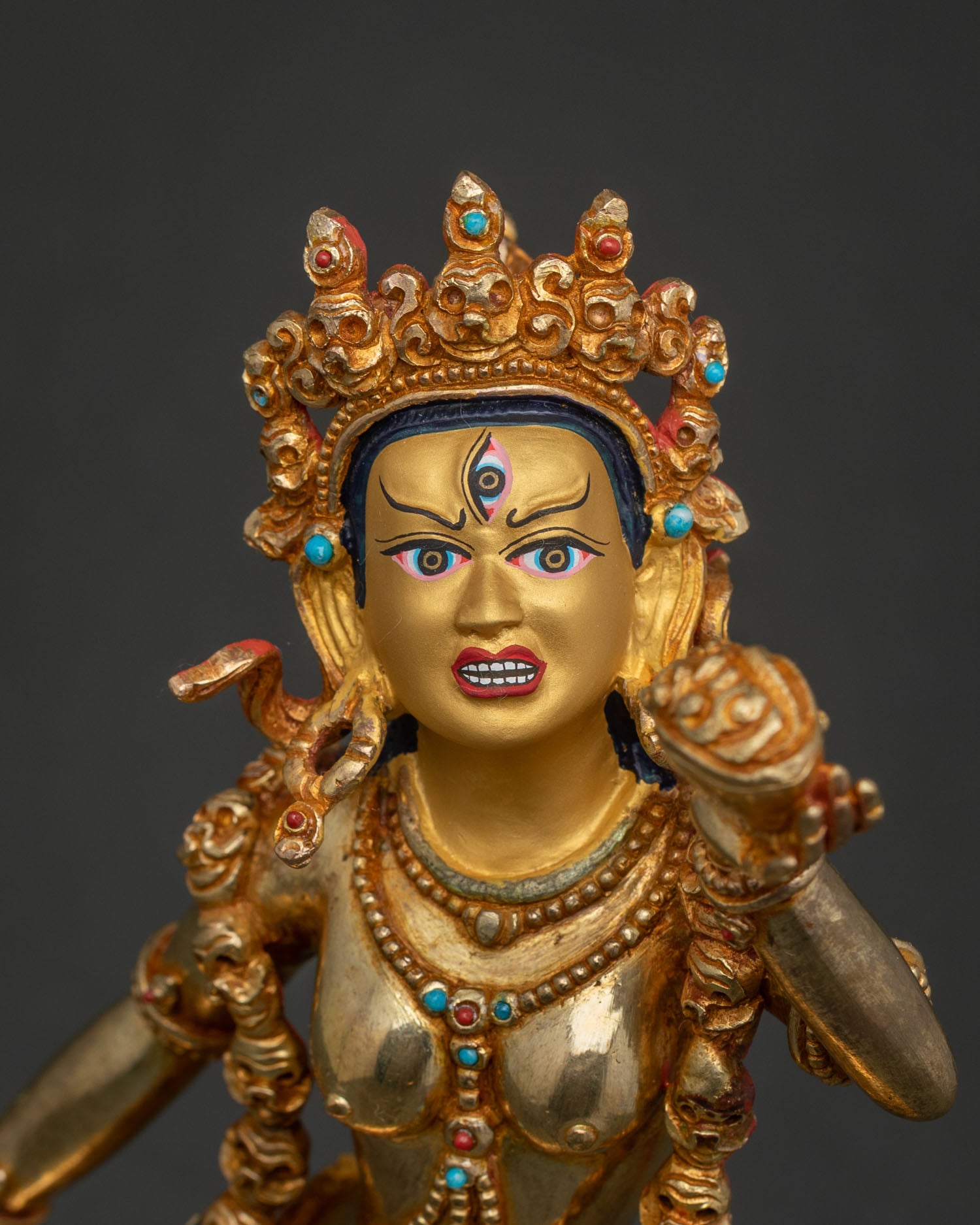 Close Up Vajrayogini Statue Gold Painted Face Five Skull Crown Details.