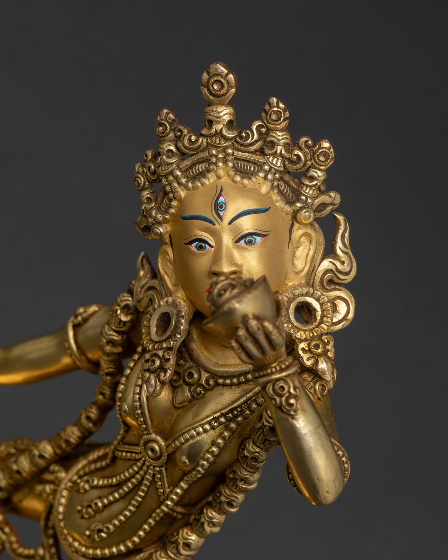 Close up Vajrayogini statue showing five skull crown gold face detailed ornaments, Himalayan craftsmanship Nepal.