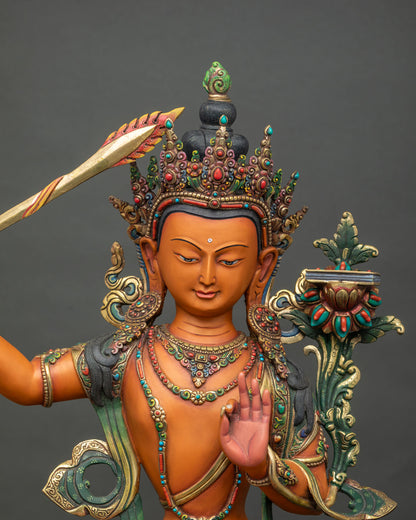 Close-up view of handmade Manjushri Statue showing intricate copper craftsmanship