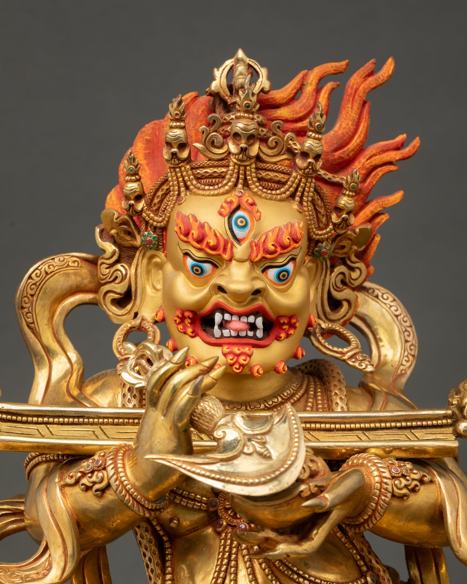 Close up view of Shakya Mahakala Buddhist statue with gold gilding and intricate details