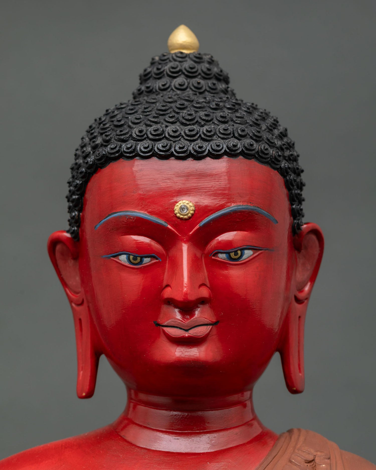 Close up view of Buddha sculpture serene face with hand painted acrylic finish showing peaceful expression symbolizing wisdom compassion and inner calm