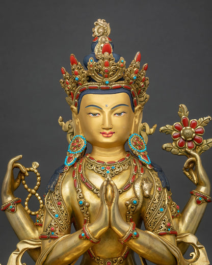 Close-up view of Chenrezig copper statue with gold fire-gilding and turquoise and coral inlay