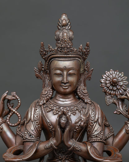 Close up view of Chenrezig statue holding crystal rosary and utpala flowers
