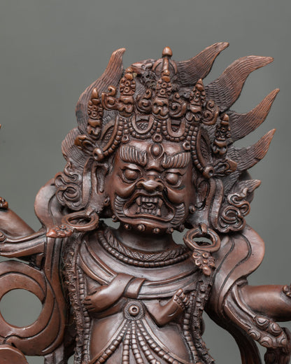 Close up view of Dorje Gotrab statue fierce wrathful face with five skull crown necklace of severed heads and detailed