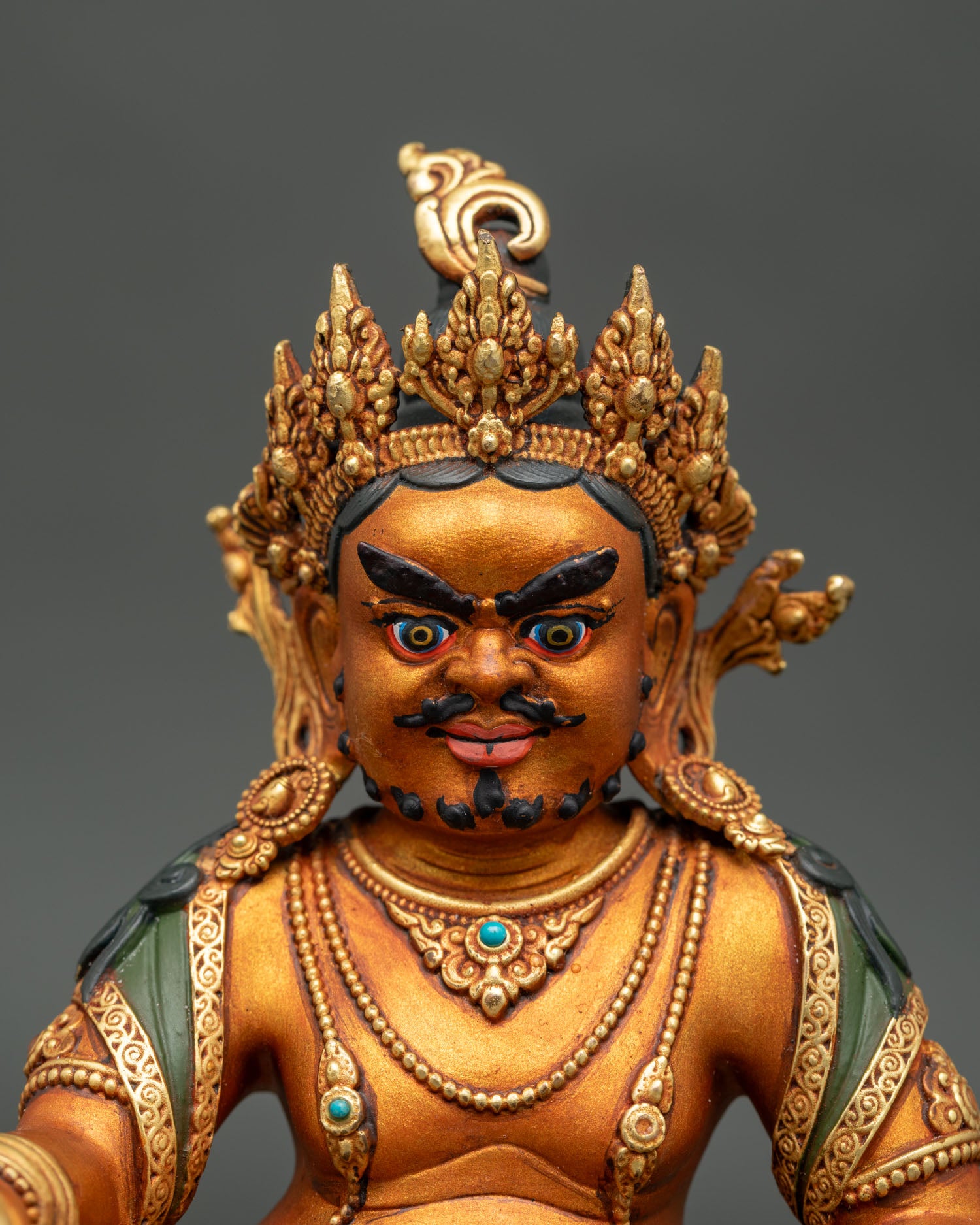 Close Up View of Gold-Gilded Dzambhala Statue with Intricate Nepalese Artisan Details