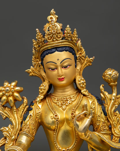 Close up view of Green Tara Buddhist goddess statue, showing compassionate expression and intricate Himalayan details