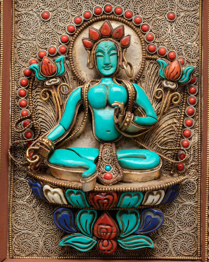 Close up view of Green Tara central figure in mandala wall hanging symbolizing compassion protection and calm spiritual energy with gold plated detailing