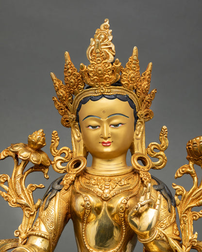 Close up view of Green Tara face with calm expression, gold details, crown and jewelry, Newari artisan Himalayan metalwork
